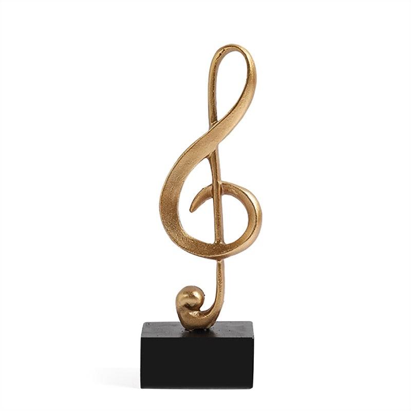 Escultura dourada de Notas Musicais - Acheiweb